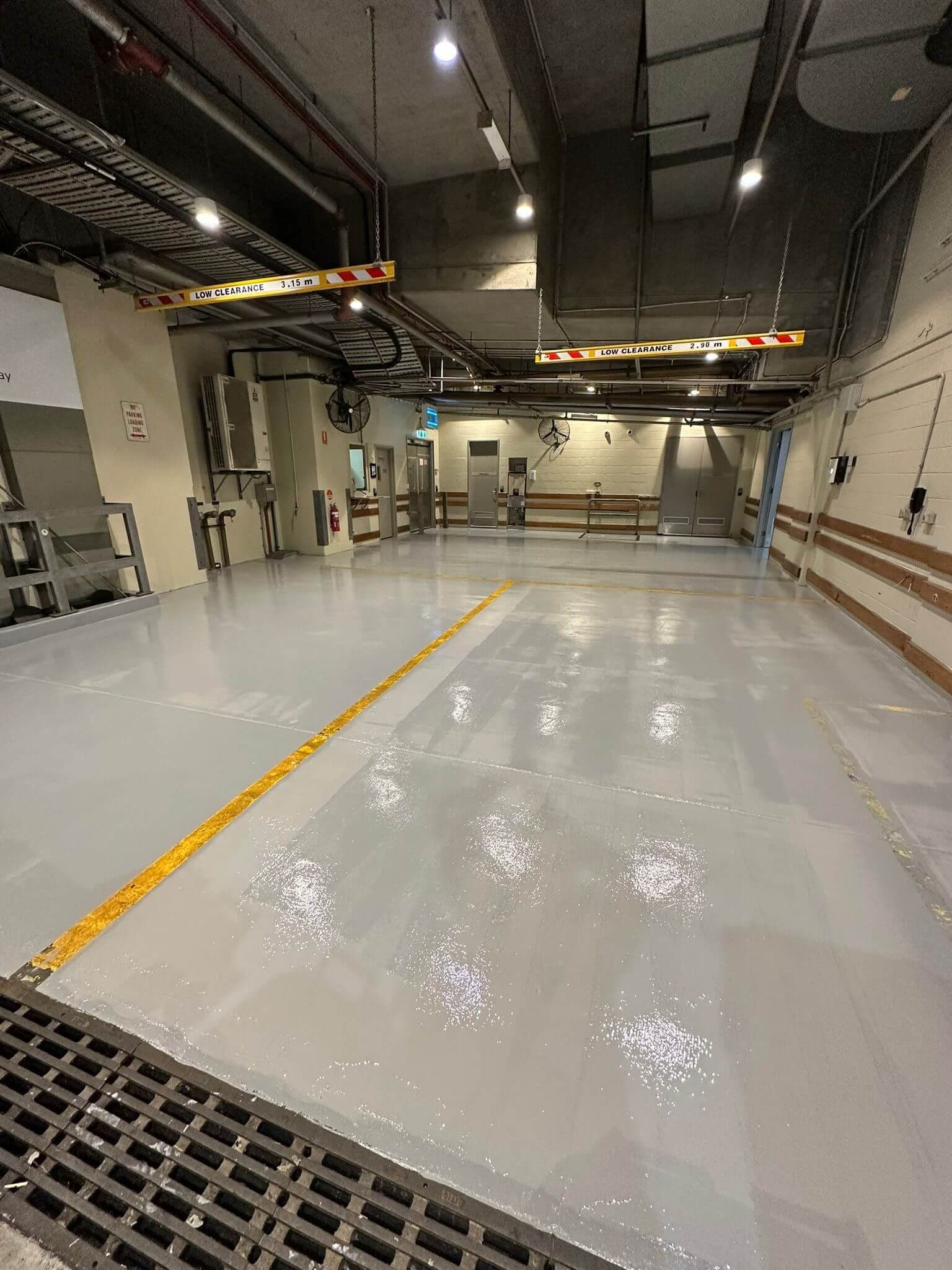 New grey protective floor coating in a commercial loading area