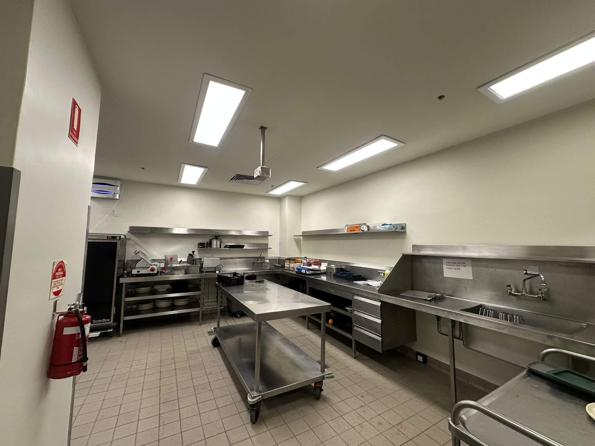 Freshly painted commercial kitchen with clean light walls and ceiling
