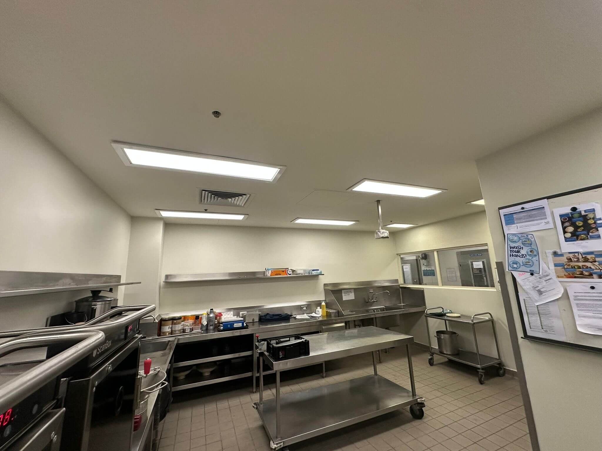 Completed commercial kitchen repaint around stainless steel work areas
