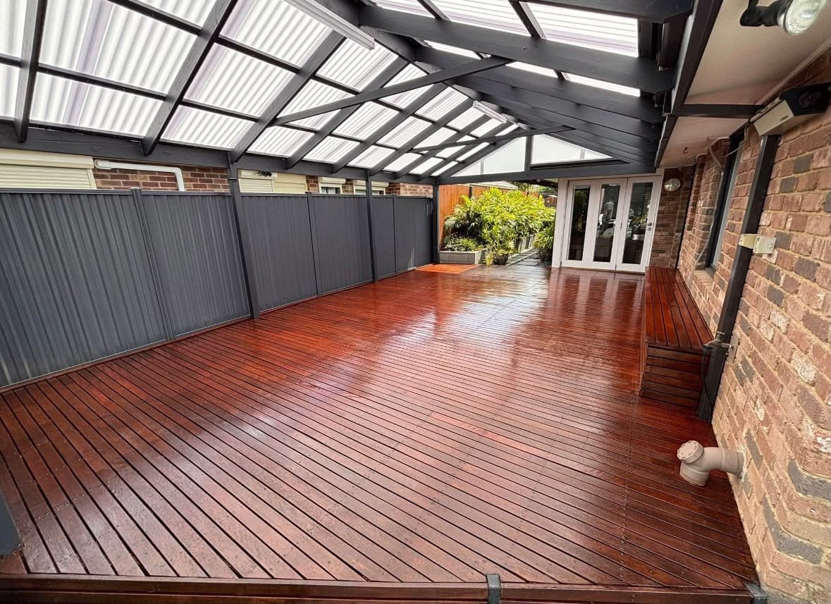 Restored timber deck beneath a charcoal covered outdoor structure