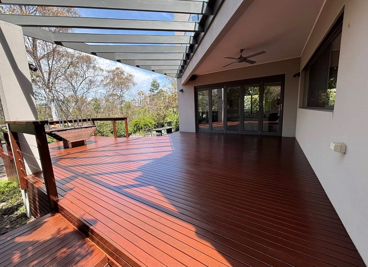 Warm timber deck beneath a glazed outdoor pergola