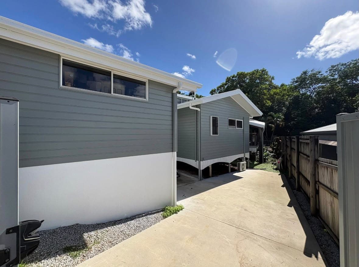 Grey weatherboard exterior finished with clean white window trim
