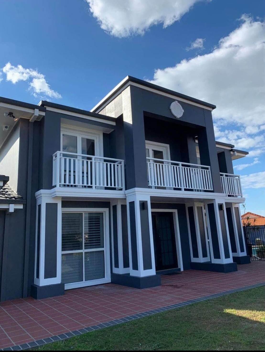 Fresh charcoal and white exterior paintwork on a two-storey home