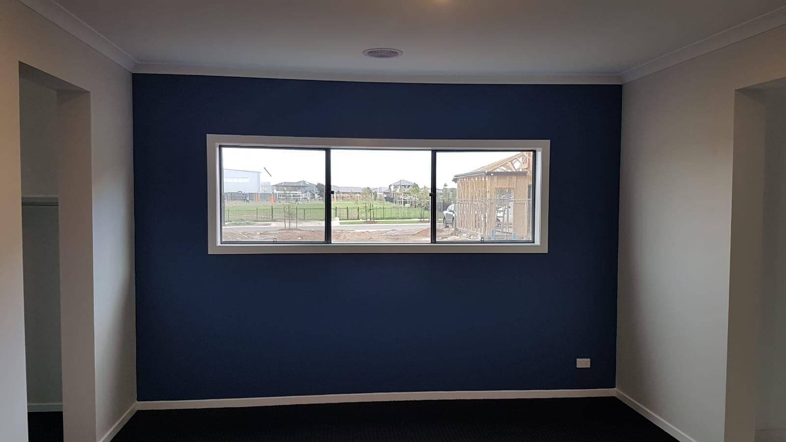 Finished interior with a deep navy feature wall and crisp white trim