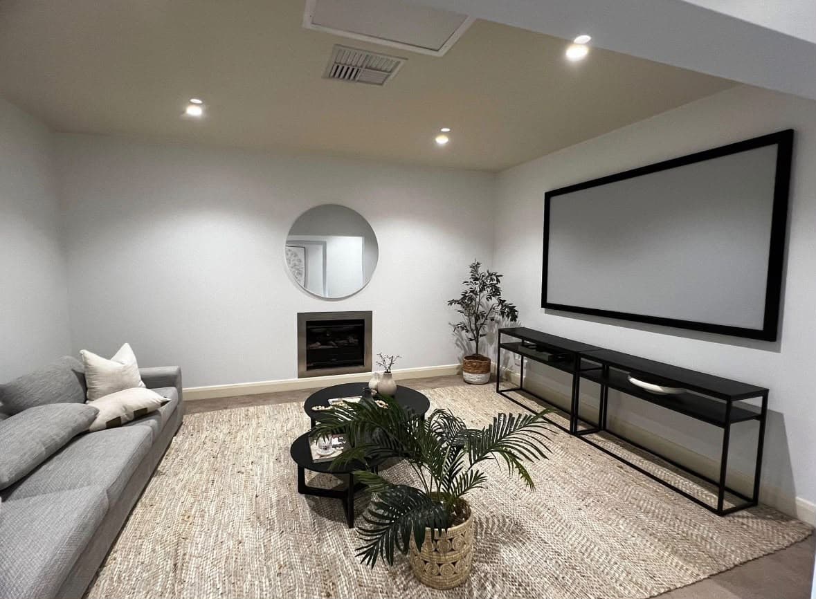 Bright white living room with a clean fireplace surround