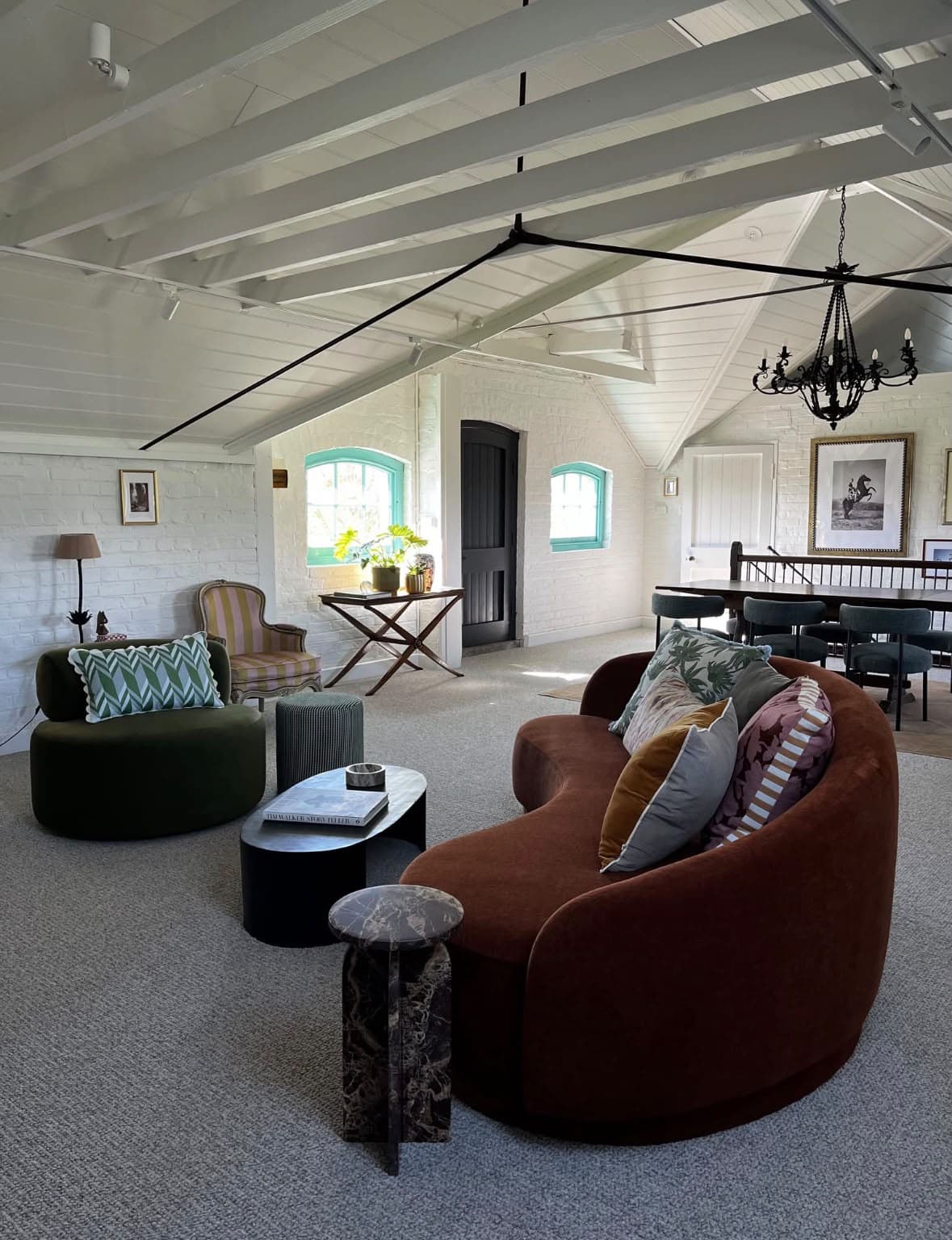 Open loft dining space with white painted beams and masonry