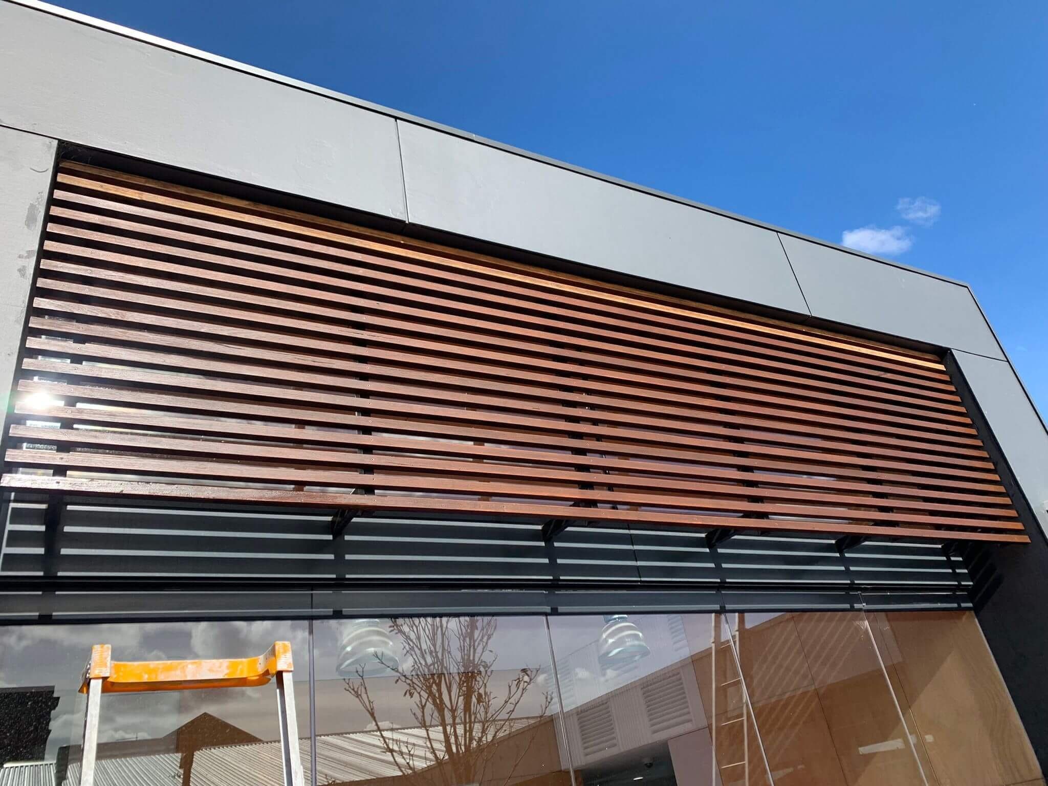 Restored timber facade battens against a modern charcoal exterior